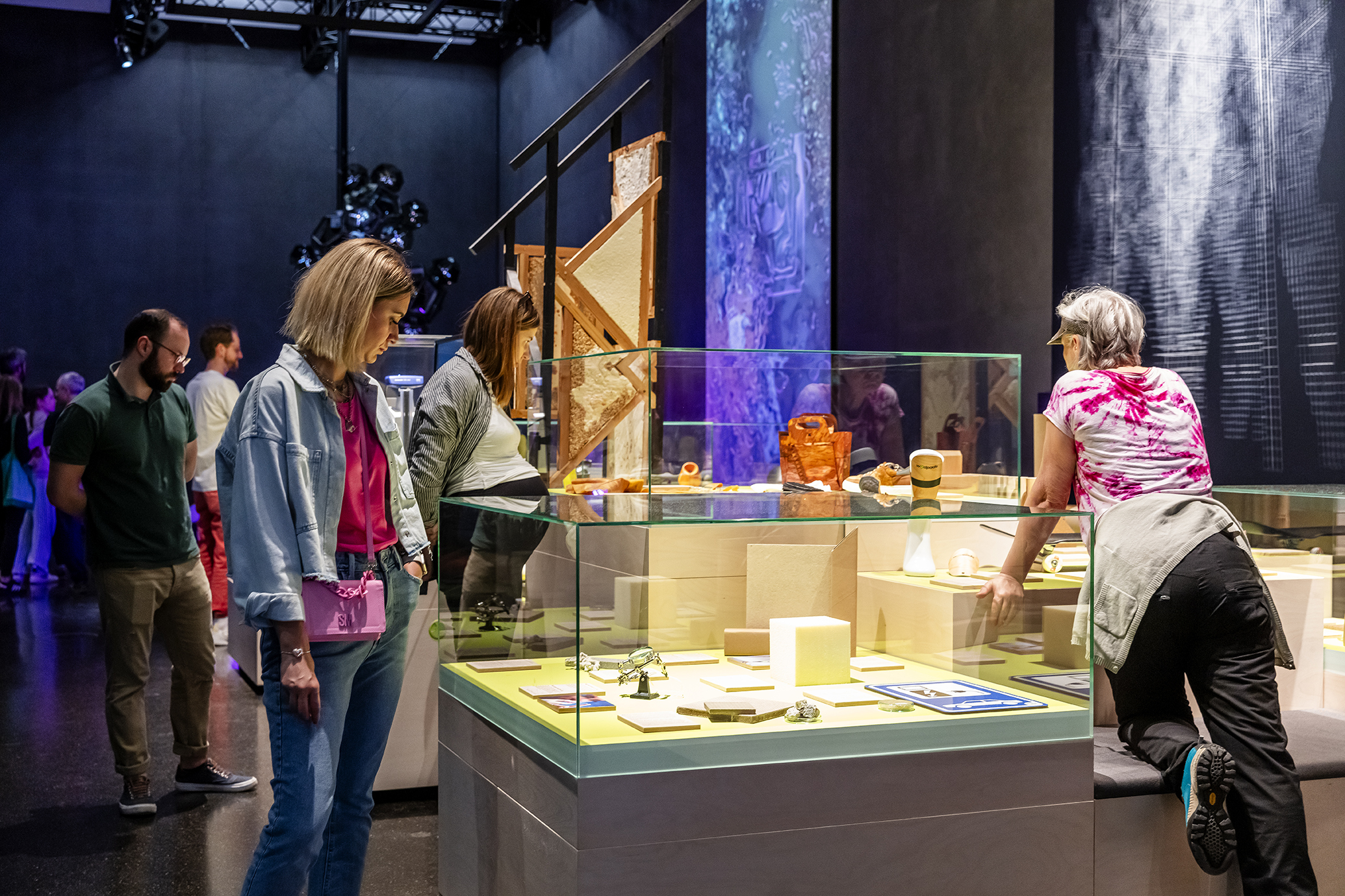 People view exhibits behind glass