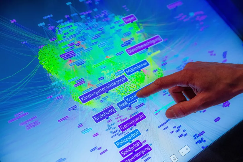 A hand points to a map with many colorful, labeled bars.