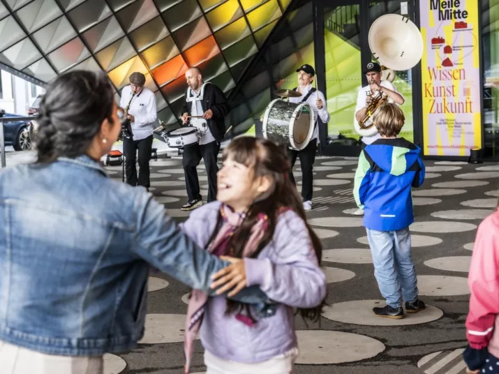People dance in front of Futurium